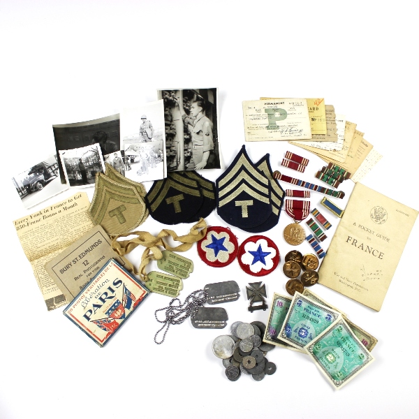 Interesting grouping of insignia, dog tags, ID documents, photos,…