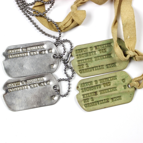 Interesting grouping of insignia, dog tags, ID documents, photos,…