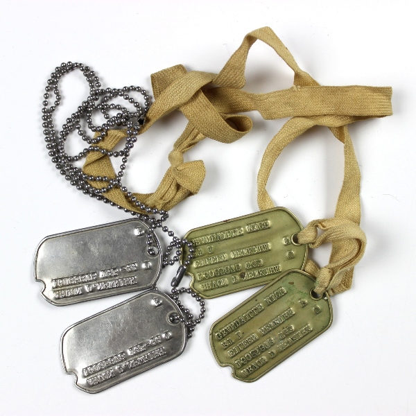 Interesting grouping of insignia, dog tags, ID documents, photos,…